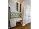 Kitchen featuring granite countertops, white cabinetry, and a built-in desk area at 112 Gingergate Dr, Cary, NC 27519