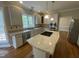 Modern kitchen with granite counters, island cooktop, stainless steel appliances, and hardwood floors at 112 Gingergate Dr, Cary, NC 27519