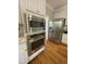 Modern kitchen appliances include built-in microwave and oven with stainless steel refrigerator at 112 Gingergate Dr, Cary, NC 27519