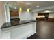 Basement kitchen with wooden cabinets, stainless steel appliances, and breakfast bar with granite countertop at 112 Gingergate Dr, Cary, NC 27519