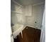 Laundry room with hardwood floors, utility sink and wire shelving at 112 Gingergate Dr, Cary, NC 27519