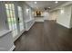 Basement living room features recessed lighting, dark hardwood floors, and french doors to the outside at 112 Gingergate Dr, Cary, NC 27519