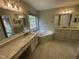 Spacious main bathroom with double vanities, granite countertops, a jacuzzi tub, and tile flooring at 112 Gingergate Dr, Cary, NC 27519