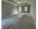 Spacious main bedroom with tray ceiling, neutral carpet, two windows, and new carpet ready for decorating at 112 Gingergate Dr, Cary, NC 27519
