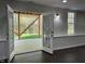 Basement living room features recessed lighting, dark hardwood floors, and french doors to the patio at 112 Gingergate Dr, Cary, NC 27519