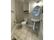 Cozy powder room featuring tile flooring, pedestal sink, a gray vanity cabinet, and an oval mirror at 112 Gingergate Dr, Cary, NC 27519