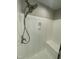 Modern shower with handheld shower head, built-in bench, and gray and white accents at 112 Gingergate Dr, Cary, NC 27519
