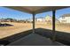 Covered patio with view of a spacious backyard surrounded by neighboring homes at 1125 Channel Drop Lp, Zebulon, NC 27597