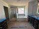 Bathroom featuring a separate shower and tub plus double vanity sinks at 1125 Channel Drop Lp, Zebulon, NC 27597