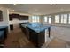 Large kitchen with dark cabinets, stainless steel appliances, and a large island at 1125 Channel Drop Lp, Zebulon, NC 27597