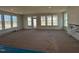 Open-concept living room area with multiple windows overlooking the backyard at 1125 Channel Drop Lp, Zebulon, NC 27597