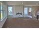 Bright living room with a fireplace, multiple windows, and an open floorplan at 1125 Channel Drop Lp, Zebulon, NC 27597