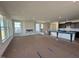Living room with a fireplace, multiple windows, and an open floorplan that leads to the kitchen at 1125 Channel Drop Lp, Zebulon, NC 27597