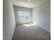Bright bedroom featuring a window providing natural light and soft carpet at 115 Central Townes Way # 300, Raleigh, NC 27603