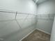 Walk-in closet features carpeted flooring and wire shelving for organization at 115 Central Townes Way # 300, Raleigh, NC 27603