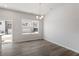 Open dining room with hardwood floors, natural light, and views of the backyard at 115 Central Townes Way # 300, Raleigh, NC 27603