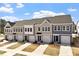 Three new townhomes with front-facing garages boast sidewalks and professionally manicured landscaping at 115 Central Townes Way # 300, Raleigh, NC 27603