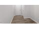 Hallway with luxury vinyl plank flooring and white painted trim and doors at 115 Central Townes Way # 300, Raleigh, NC 27603