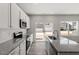 Bright kitchen features granite countertops, stainless steel appliances, and white cabinetry at 115 Central Townes Way # 300, Raleigh, NC 27603