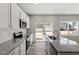 Modern kitchen with an island, granite countertops, stainless steel appliances, and new backsplash at 115 Central Townes Way # 300, Raleigh, NC 27603