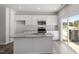 New kitchen with island, granite countertops, modern appliances, and luxury vinyl plank flooring at 115 Central Townes Way # 300, Raleigh, NC 27603