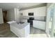 New kitchen with stainless steel appliances, granite counters, an island, and white shaker cabinets at 115 Central Townes Way # 300, Raleigh, NC 27603