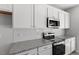 Close up of the kitchen features stainless steel appliances, white cabinetry, and subway tile backsplash at 115 Central Townes Way # 300, Raleigh, NC 27603