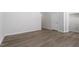 Neutral living room with a view of a doorway, light walls, and hardwood floors at 115 Central Townes Way # 300, Raleigh, NC 27603