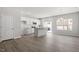 Open-concept living room and kitchen with hardwood floors and plenty of natural light at 115 Central Townes Way # 300, Raleigh, NC 27603