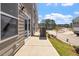 View of the outdoor patio area with exterior features and landscaping on a sunny day at 115 Central Townes Way # 300, Raleigh, NC 27603