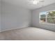 Bedroom with soft neutral carpet, grey walls and view out of a double paned window at 116 Fideaux Blvd # 258, Raleigh, NC 27603