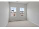 Neutral carpeted bedroom with white walls and a view of the construction from 2 double paned windows at 116 Fideaux Blvd # 258, Raleigh, NC 27603