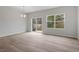 Bright dining area with wood-look flooring and large windows offering plenty of natural light at 116 Fideaux Blvd # 258, Raleigh, NC 27603