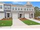 Attractive townhomes with a pleasing color scheme, well-kept landscaping, and individual garages for each unit at 116 Fideaux Blvd # 258, Raleigh, NC 27603