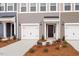 Attractive townhomes with individual garages and inviting front entrances enhanced by fresh landscaping at 116 Fideaux Blvd # 258, Raleigh, NC 27603