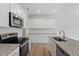 A well-lit kitchen features granite countertops, stainless steel appliances, and ample cabinet space for storage at 116 Fideaux Blvd # 258, Raleigh, NC 27603