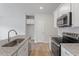 A well-lit kitchen features granite countertops, stainless steel appliances, and ample cabinet space for storage at 116 Fideaux Blvd # 258, Raleigh, NC 27603