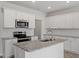 A bright kitchen with stainless steel appliances, granite countertops, and white cabinets presents an inviting space at 116 Fideaux Blvd # 258, Raleigh, NC 27603