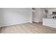 Open-concept living room with wood-look floors, and a seamless flow into the kitchen area at 116 Fideaux Blvd # 258, Raleigh, NC 27603