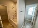 Bathroom with tub/shower combo and a separate room with a toilet and window at 119 Central Townes Way # 301, Raleigh, NC 27603