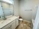 Bathroom featuring a single sink vanity, toilet, and a shower-tub combo at 119 Central Townes Way # 301, Raleigh, NC 27603