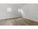 Bedroom with wood floors, natural light from multiple windows, and closet at 119 Central Townes Way # 301, Raleigh, NC 27603
