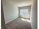 A bright bedroom with neutral carpet and a window letting in natural light at 119 Central Townes Way # 301, Raleigh, NC 27603