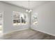 Bright dining room with wood floors and natural light from multiple windows at 119 Central Townes Way # 301, Raleigh, NC 27603