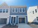 Charming two-story home featuring a garage, neat landscaping, and a welcoming front entrance at 119 Central Townes Way # 301, Raleigh, NC 27603