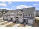 Aerial view of townhomes featuring sidewalks, garages, and manicured lawns at 119 Central Townes Way # 301, Raleigh, NC 27603