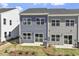 Townhome exterior with a small yard and sliding glass doors at 119 Central Townes Way # 301, Raleigh, NC 27603