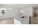 Open concept kitchen with granite island, stainless steel appliances, and modern light fixture at 119 Central Townes Way # 301, Raleigh, NC 27603