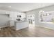 Open-concept kitchen with white cabinets, stainless steel appliances, and island at 119 Central Townes Way # 301, Raleigh, NC 27603