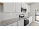 Modern kitchen featuring white cabinets, granite countertops, stainless steel appliances and subway tile backsplash at 119 Central Townes Way # 301, Raleigh, NC 27603
